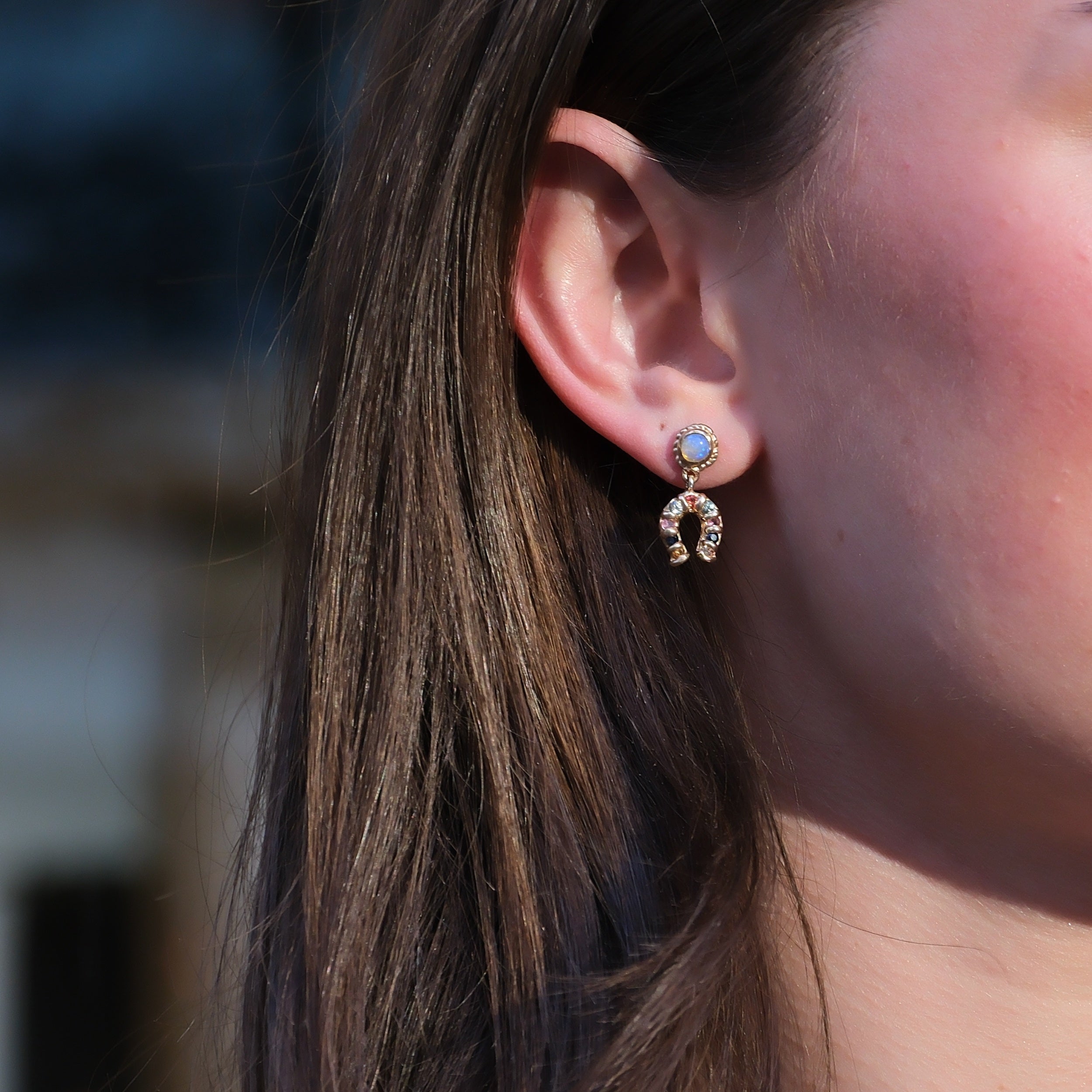 opal horseshoe sapphire earring on woman designer ciara bowles