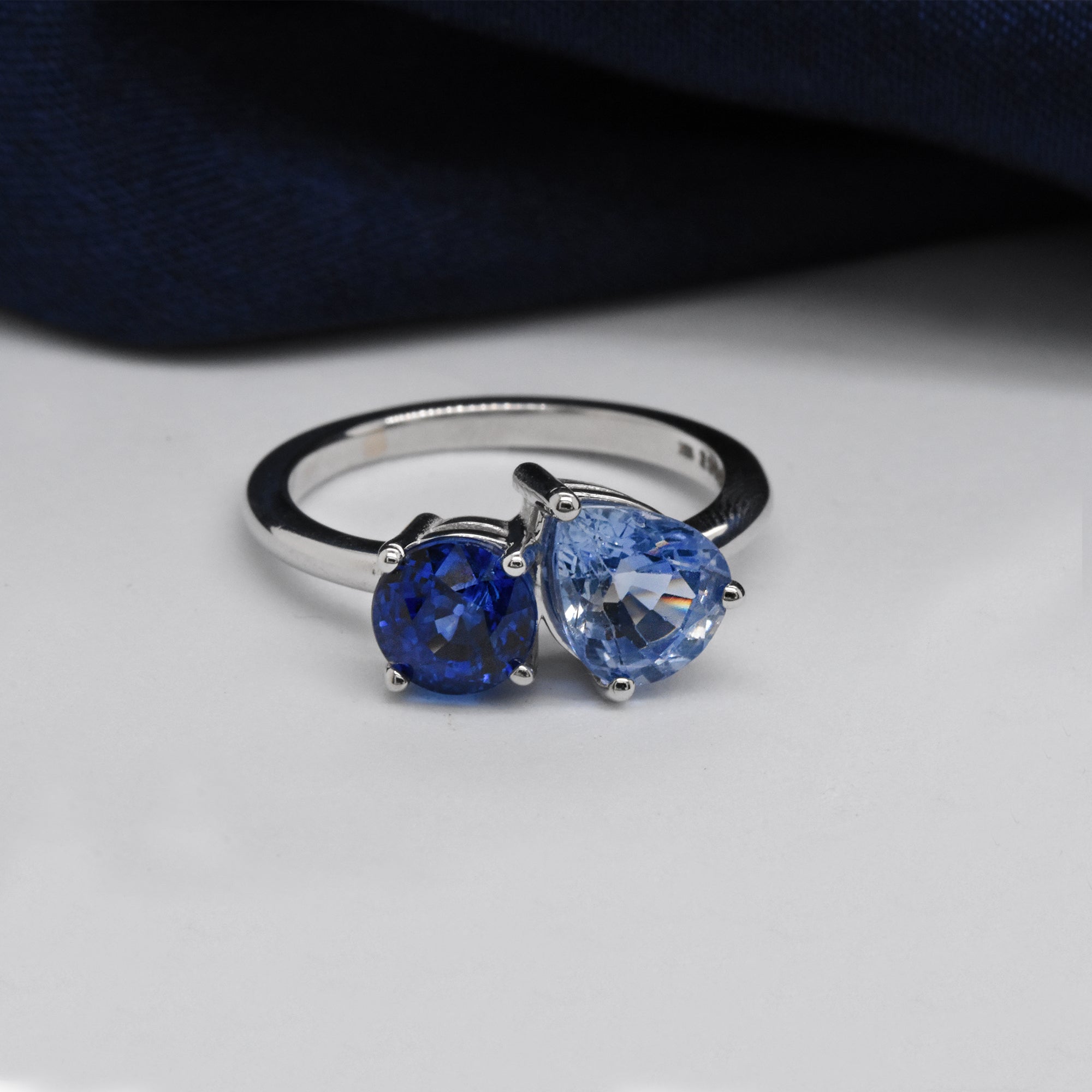 Heirloom Deep Blue Round Sapphire and Ice Blue Montana Pear Sapphire in a 14k White Gold Toi Et Moi Setting