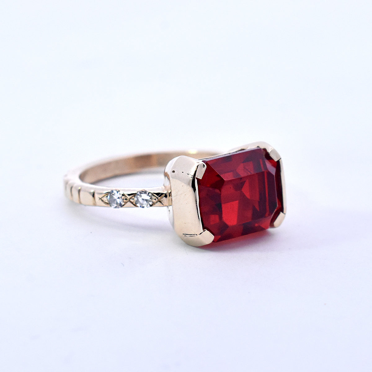 Emerald-Cut Red Glass Stone with Flush Set Diamonds on a Cobblestone Textured Band