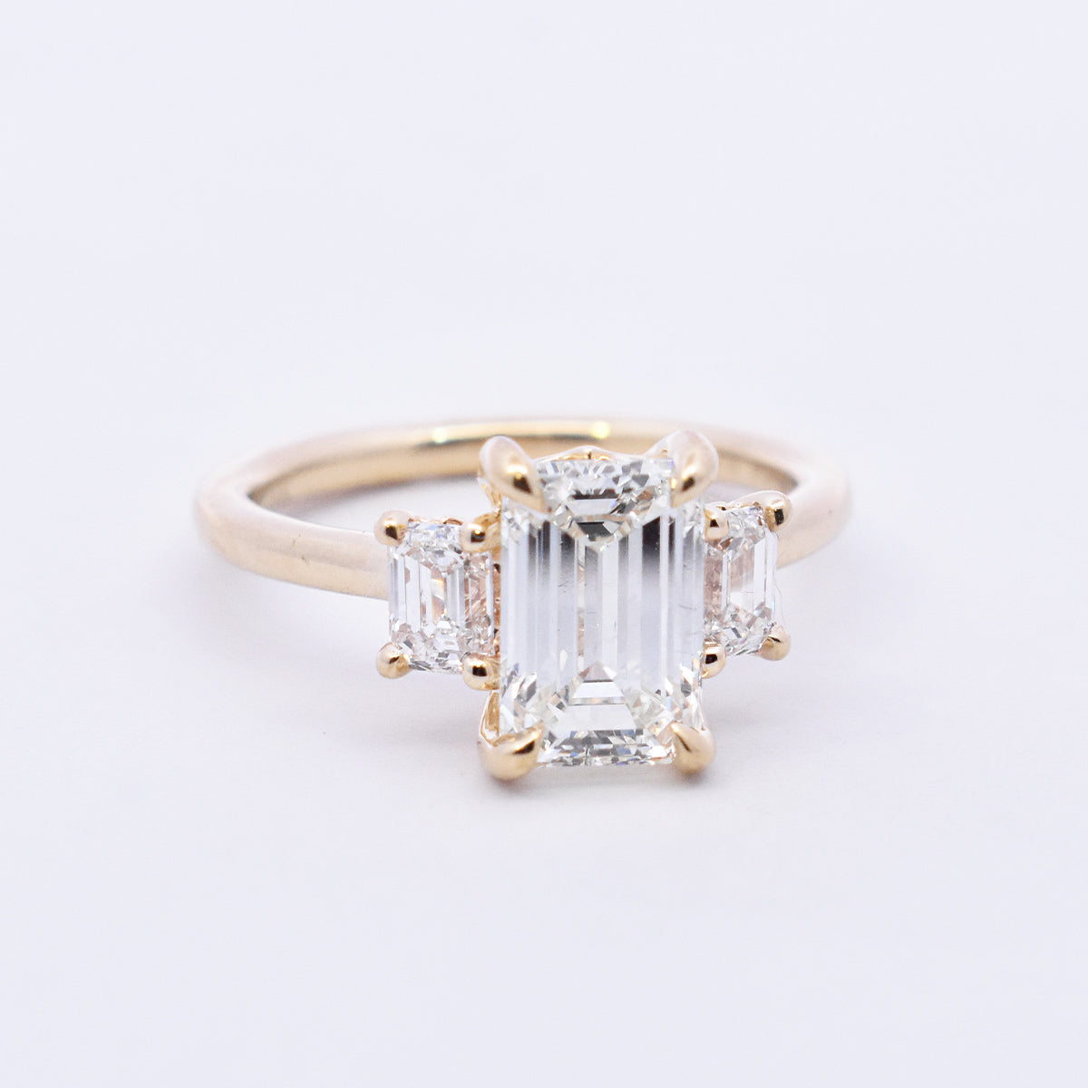 Three-Stone Emerald-Cut Diamond with Baguette Side Stones & Hidden Halo Engagement Ring