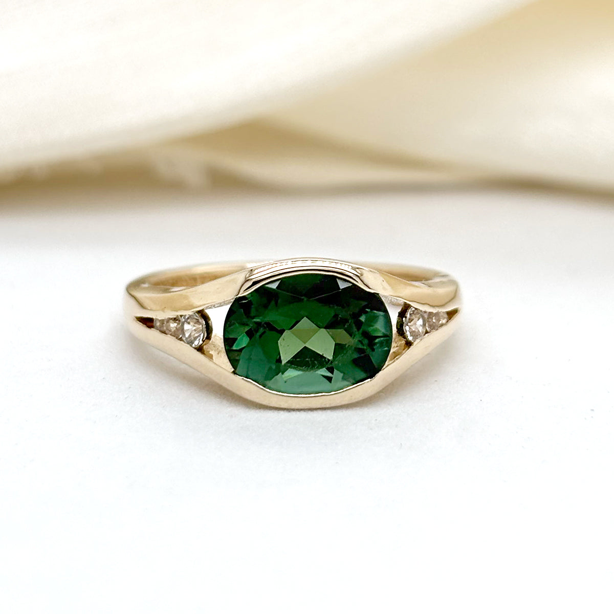 Art Deco East/West Emerald Set In A Split Shank Band With Diamond Side Accents